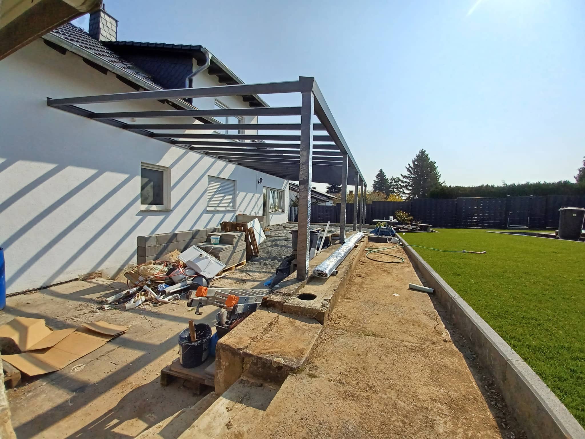 Montagesituation eines Terrassendachs: aufgestelltes Aluminium-Tragwerk vor dem Eindecken